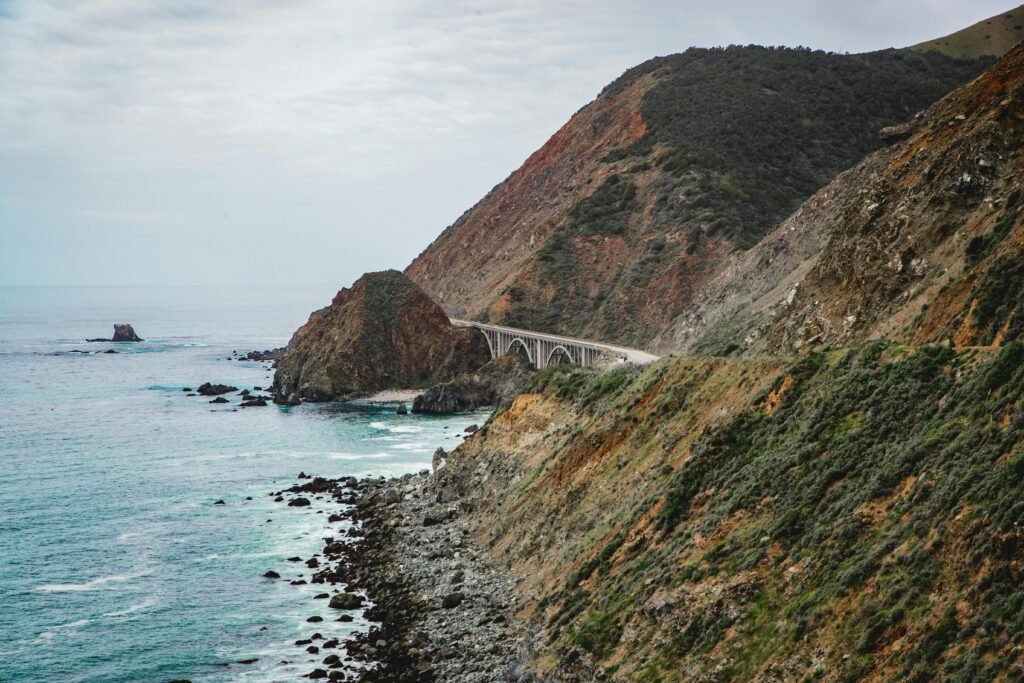 Captivating view of a coastal highway bridging rocky cliffs and the ocean.